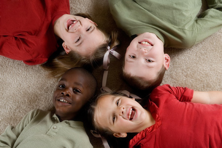 children laying on the floor together and smiling