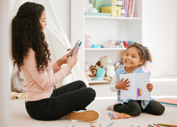 Mother and daughter making a memory book